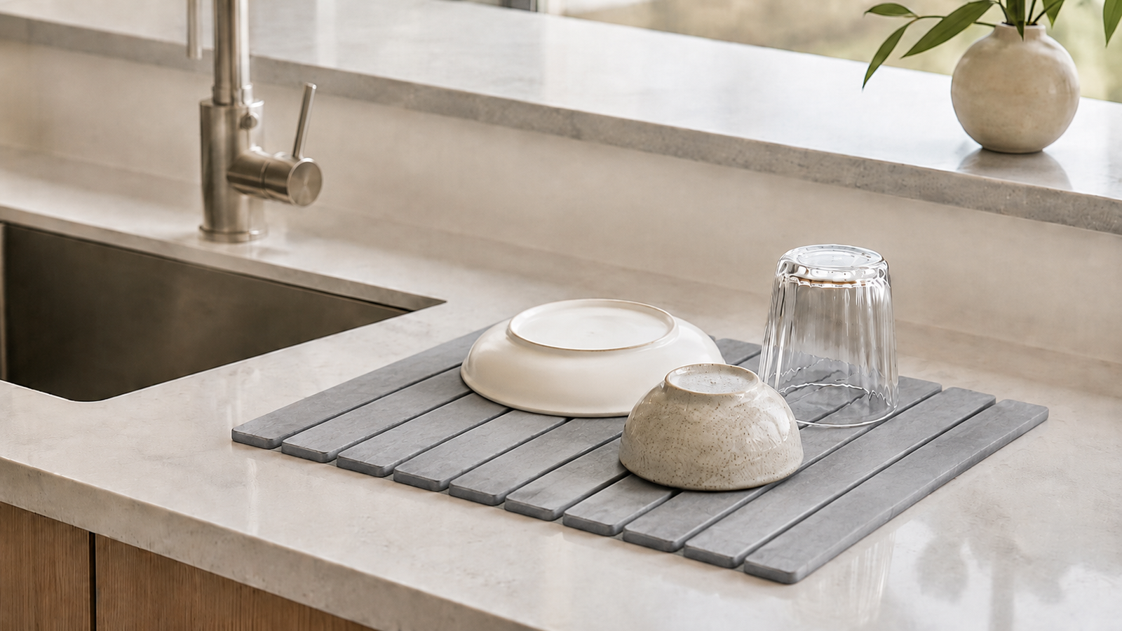 Diatomite stone drying mat on a kitchen counter in a modern minimalist kitchen