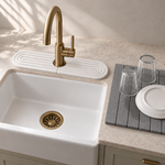 White — White stone faucet mat beside a farmhouse sink and the Trivelle stone drying mat