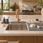 The Trivelle Complete Kitchen Set on a kitchen counter: stone drying mat holding glasses and a pan, sink caddy, faucet mat, soap tray and coasters