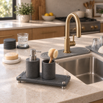The Trivelle stone sink caddy raised on stainless steel legs, holding a stone utensil cup. Soap dispenser and dish brush shown for styling, not included