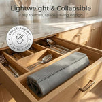 Stone drying mat rolled up for storage inside a kitchen cutlery drawer
