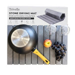 Trivelle stone drying mat with retail box — gray diatomite slats holding a wok, two glasses, an apple, and grapes