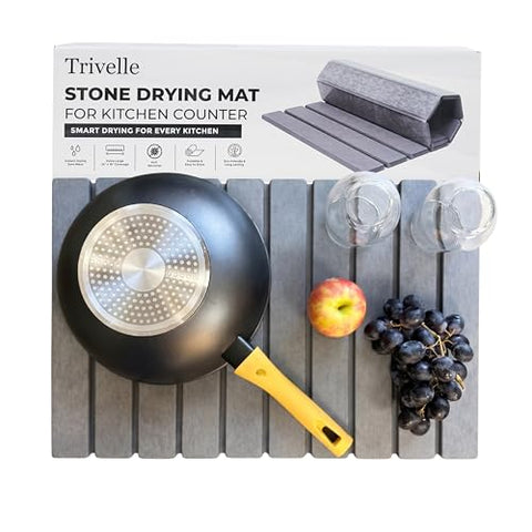 Trivelle stone drying mat with retail box — gray diatomite slats holding a wok, two glasses, an apple, and grapes