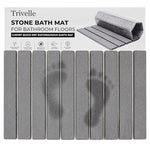 Trivelle stone bath mat with retail box — gray diatomite slats showing wet footprints fading as they dry