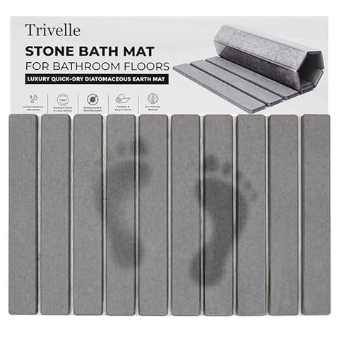Trivelle stone bath mat with retail box — gray diatomite slats showing wet footprints fading as they dry