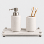 White — White stone vanity tray with a matching soap pump and toothbrush cup