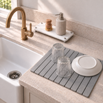 White — White stone sink caddy beside the Trivelle stone drying mat by a farmhouse sink