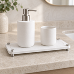White — White stone sink caddy with a soap pump and cup on a bathroom counter