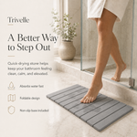 Stepping out of the shower onto the stone bath mat as wet footprints dry