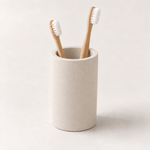 Beige — Beige stone brush cup holding two bamboo toothbrushes