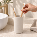 Beige — Placing a bamboo toothbrush into the beige stone brush cup