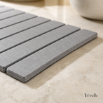 Close-up of the diatomite stone slats and folding hinge of the drying mat on a stone counter