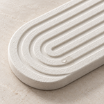 White — Close-up of the white stone faucet mat grooves with a water droplet