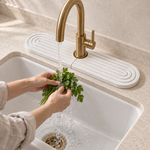 White — White stone faucet mat catching splashes behind a kitchen faucet