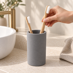 Dark Gray — Placing a bamboo toothbrush into the dark gray stone brush cup