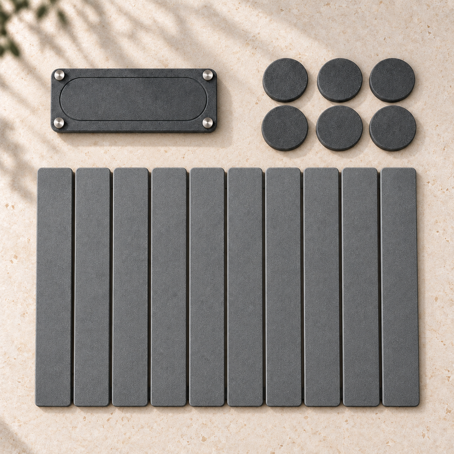 Everything in the Trivelle Essential Kitchen Set laid flat: the stone drying mat, the stone sink caddy and six stone coasters