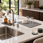 The Essential Kitchen Set around a kitchen sink: stone drying mat with a bowl and glasses, sink caddy and coasters. Soap bottle, brush, bowl and glasses shown for styling, not included