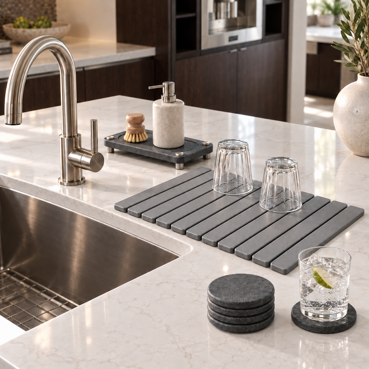 The Essential Kitchen Set on a kitchen island beside the sink. Soap dispenser, brush and glasses shown for styling, not included