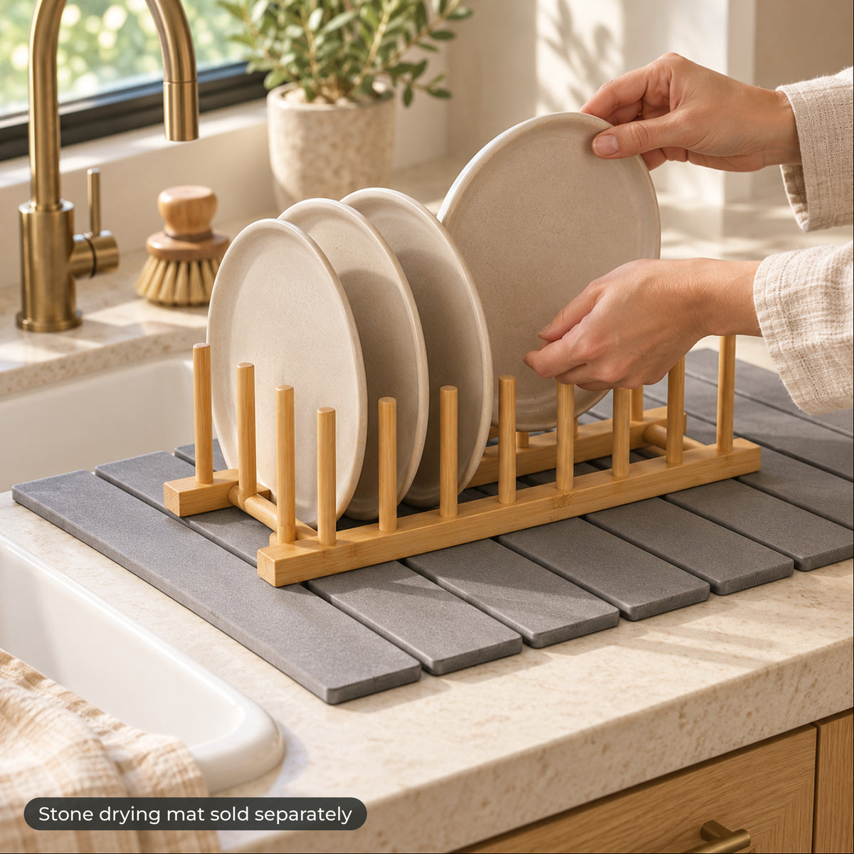 Hands sliding a plate into the bamboo rack on a stone drying mat, mat sold separately