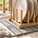 Close-up of the bamboo pegs and rail resting on gray stone slats, mat sold separately