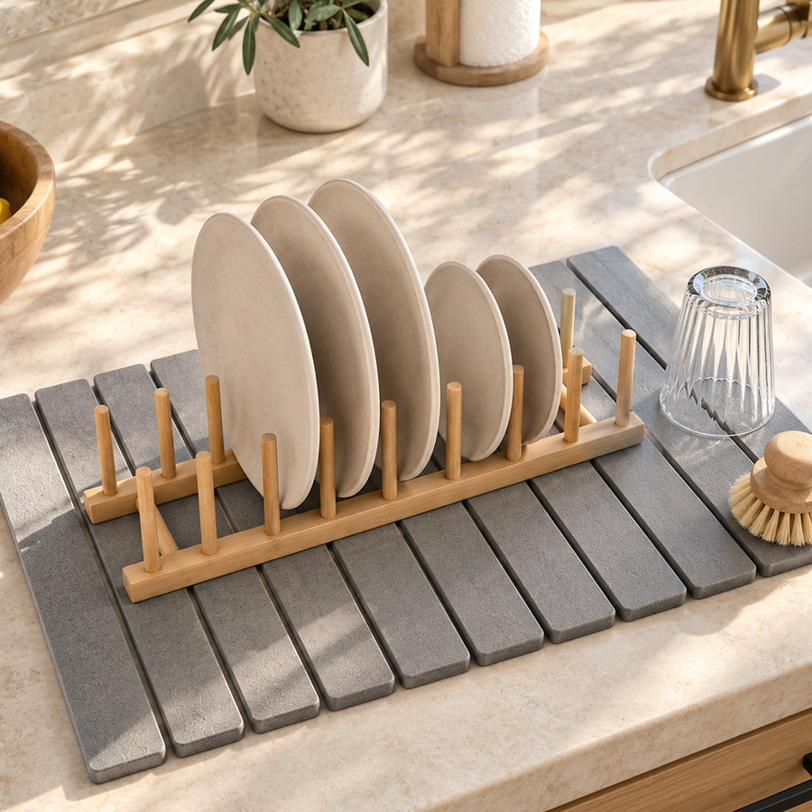 After: the same plates standing upright in the bamboo plate rack on the stone mat